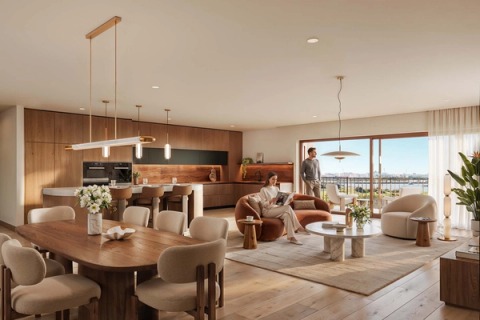 Dining area with a timber table, kitchen and open-plan living room overlooking the river.