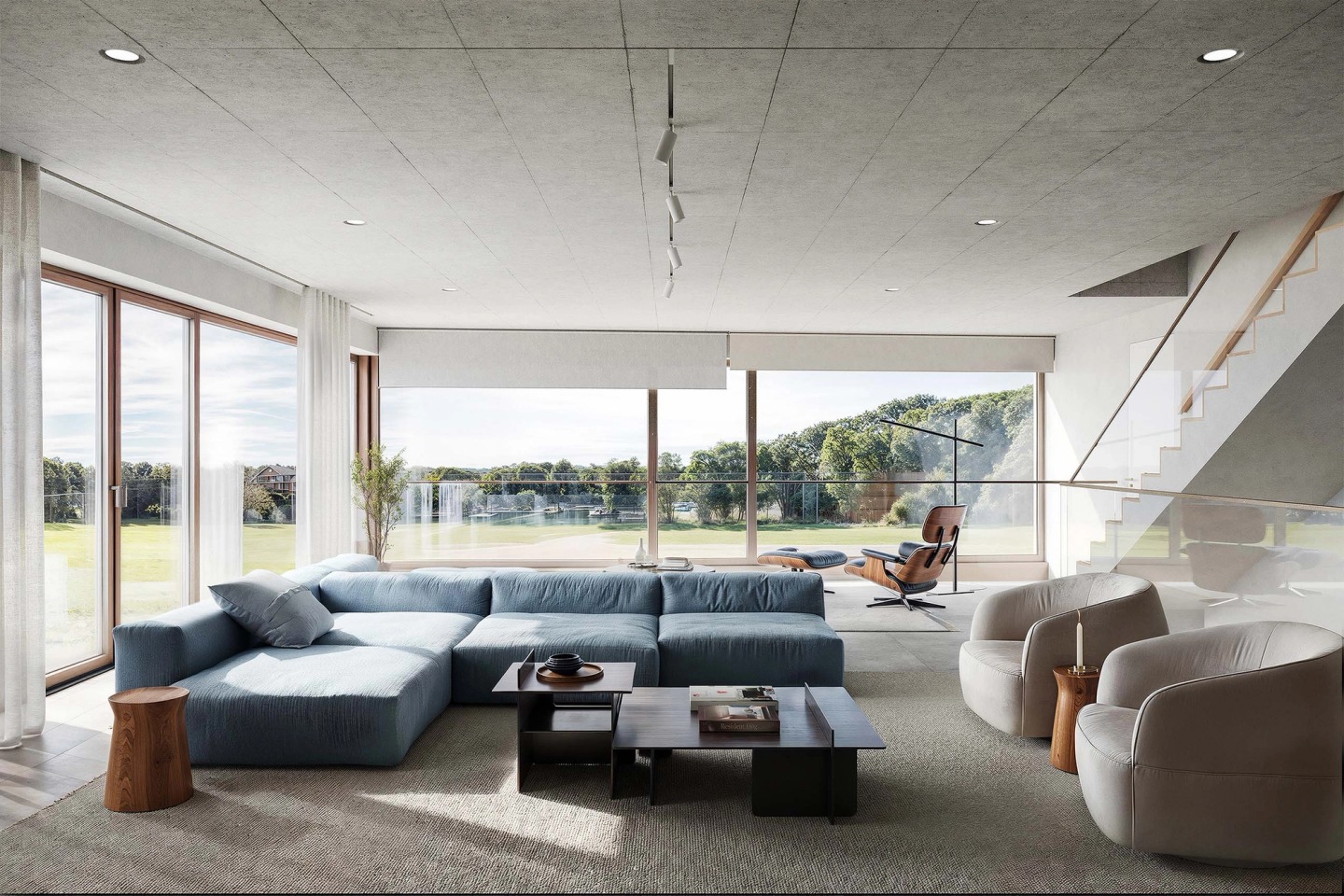 Living room with a blue sofa, concrete ceiling and floor-to-ceiling windows onto the fields, in the Joho house.