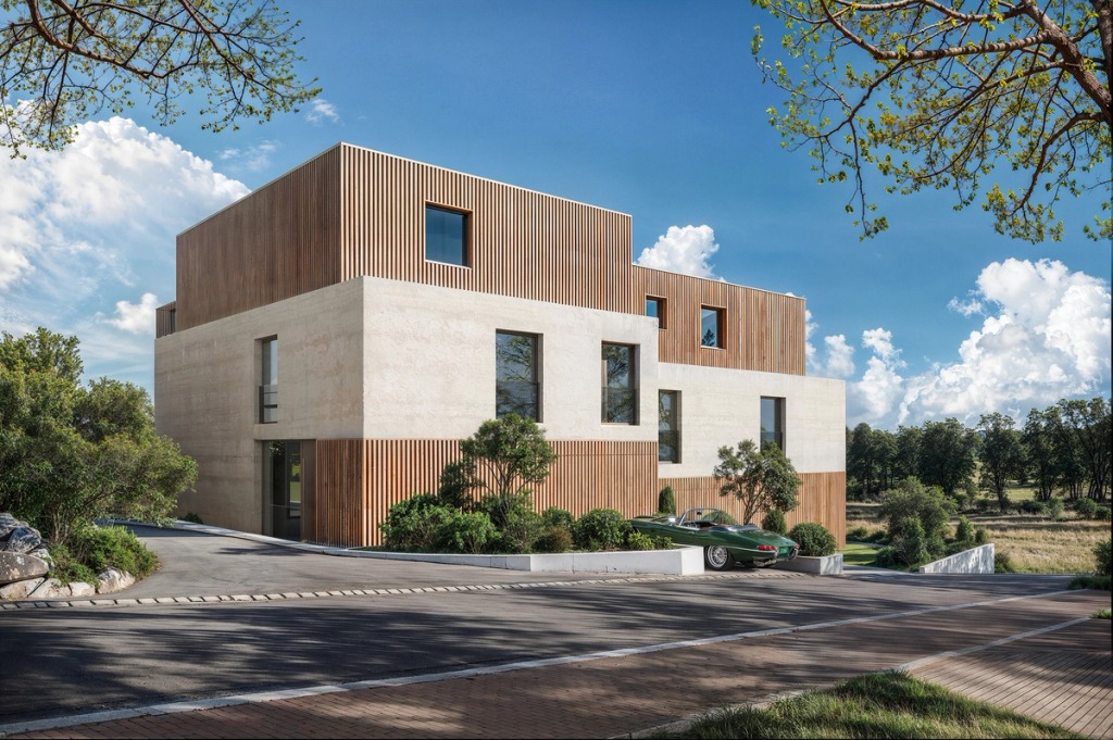 The Joho house in Luxembourg seen from the street, in light concrete and timber slats, among trees.
