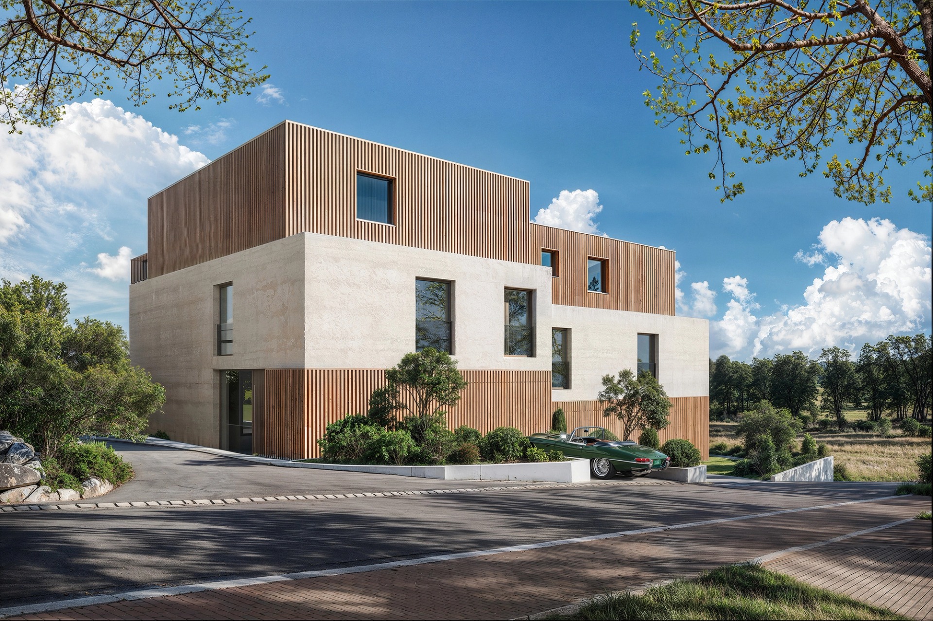 The Joho house in Luxembourg seen from the street, in light concrete and timber slats, among trees.