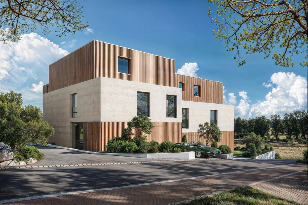 The Joho house in Luxembourg seen from the street, in light concrete and timber slats, among trees.