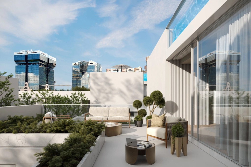 Terrace with outdoor sofas and plants beside the raised pool, with the Amoreiras towers in the background.