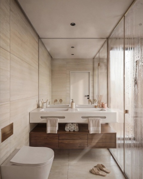 Bathroom with a floating timber vanity, light stone cladding and a glass shower.