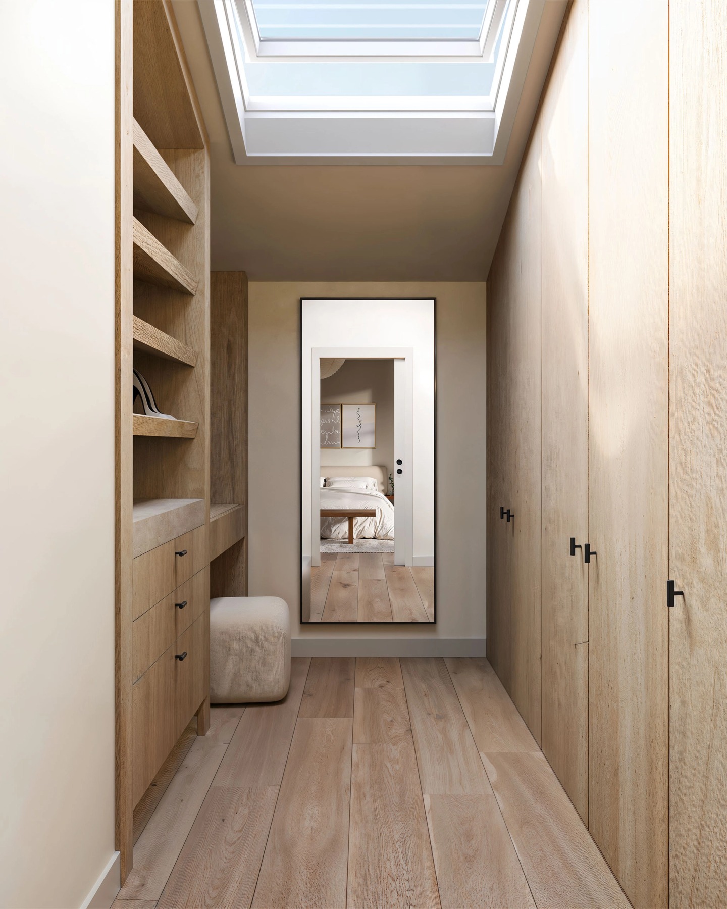 Walk-in wardrobe in light timber with a skylight and a full-length mirror at the end.