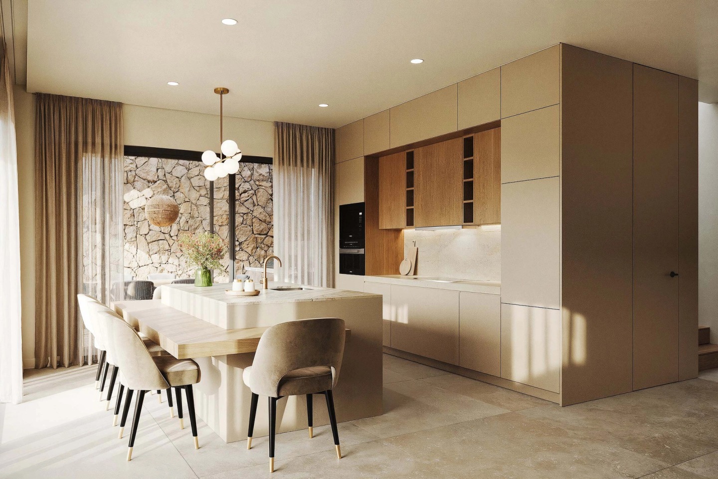 Kitchen with an island and dining table, a stone wall visible through the window, in a Pearl Villas house.