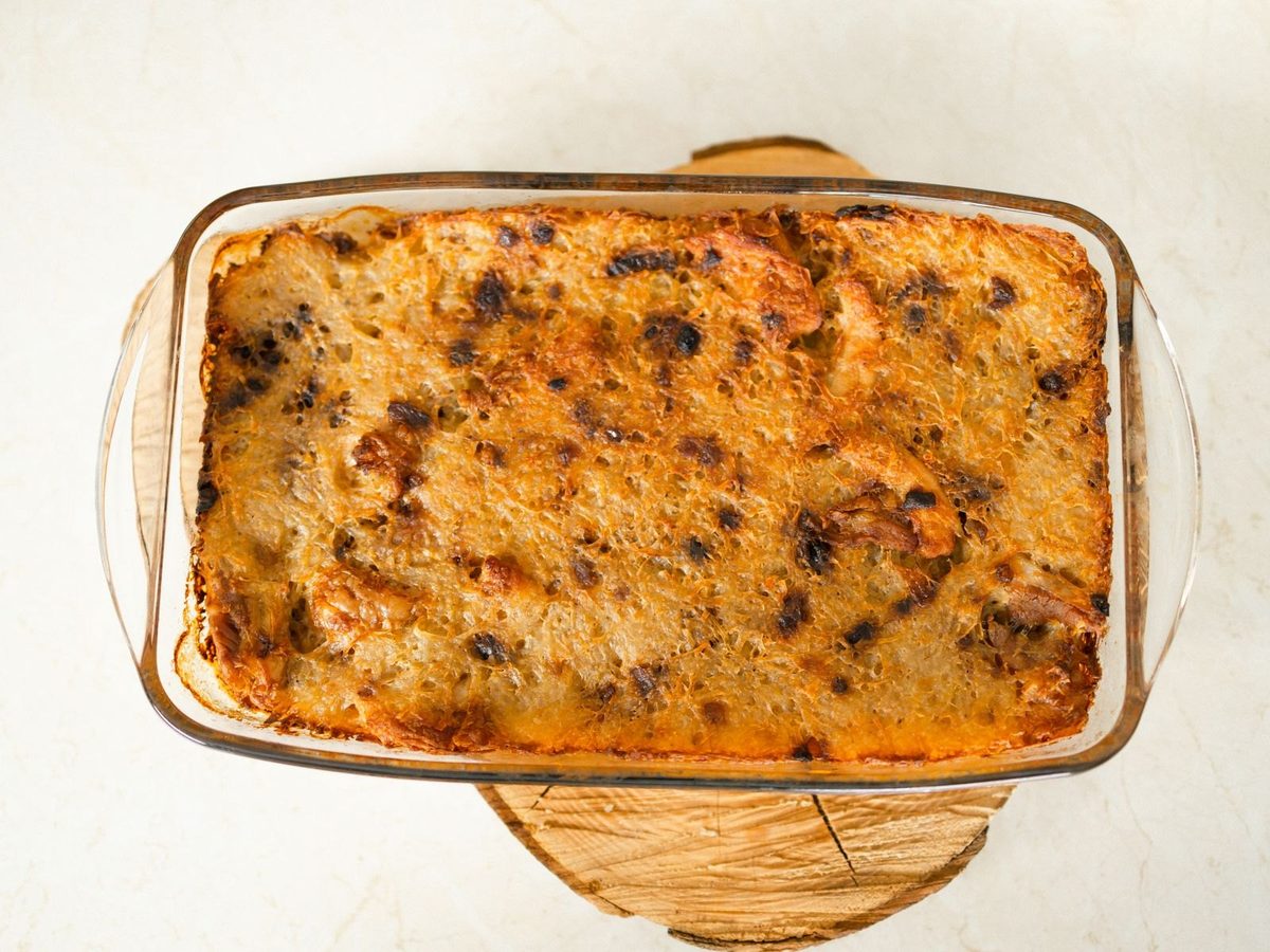 A golden far breton with prunes, baked in a rectangular glass dish.