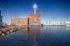 Preview of: Luftudsigt over havneområde med marinaer, bygninger, jernbane og fodboldbaner