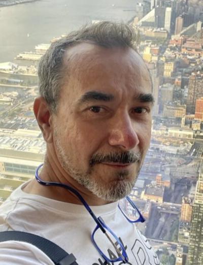 George M., senior master HVAC technician at Art HVAC, with the New York City skyline behind him