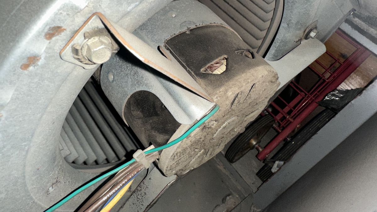 Art HVAC Technician Brushing Dust Out of a Commercial Supply Duct During a NYC Office Duct Cleaning Service Visit