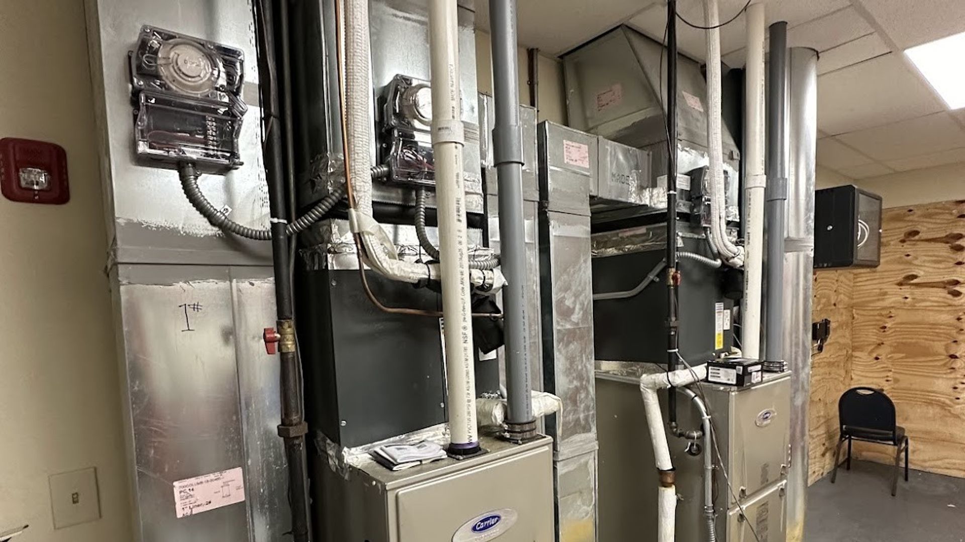 Art HVAC Technician Clearing a Clogged HVAC Condensate Drain Line at a NYC Commercial Office Building HVAC Service