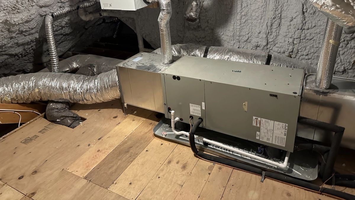 Art HVAC Technician Programming a Honeywell Commercial Thermostat and Zone Controller at a NYC Office Building