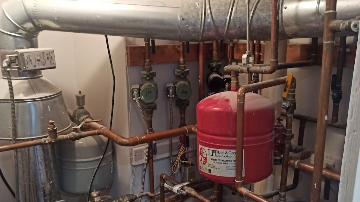 Art HVAC Plumber Checking a Commercial Water Heater and Shutoff Valves During a NYC Plumbing Maintenance Checklist
