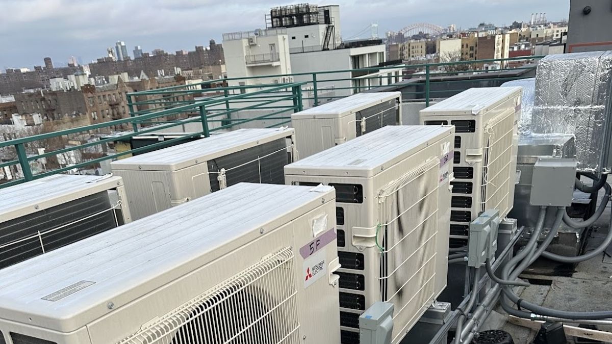 Art HVAC Crew Rigging a Heat Pump Outdoor Unit Onto a NYC Residential Rooftop During a Heat Pump Installation Day