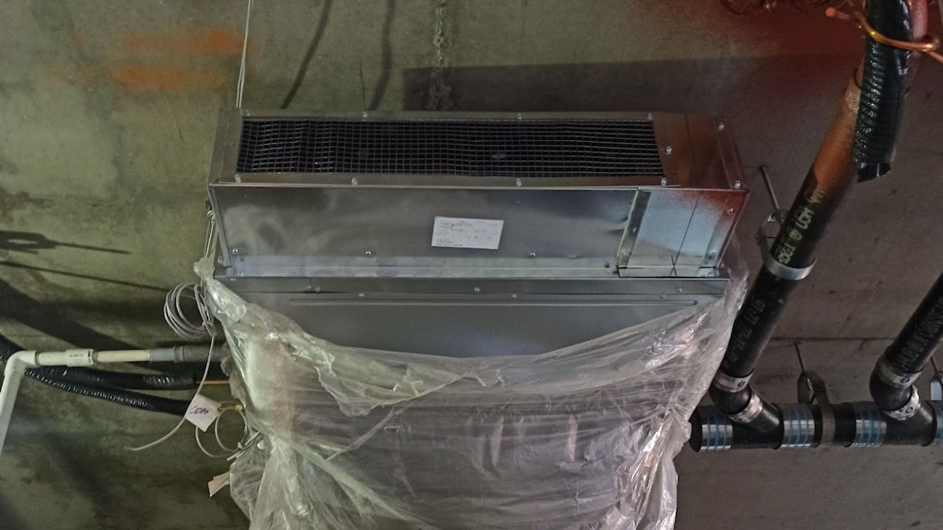 Art HVAC Crew Hanging New Spiral Commercial Ductwork Above a NYC Office Ceiling During HVAC Installation Project