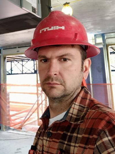 Artem T., founder and lead master HVAC technician at Art HVAC, in a hard hat on a New York City job site