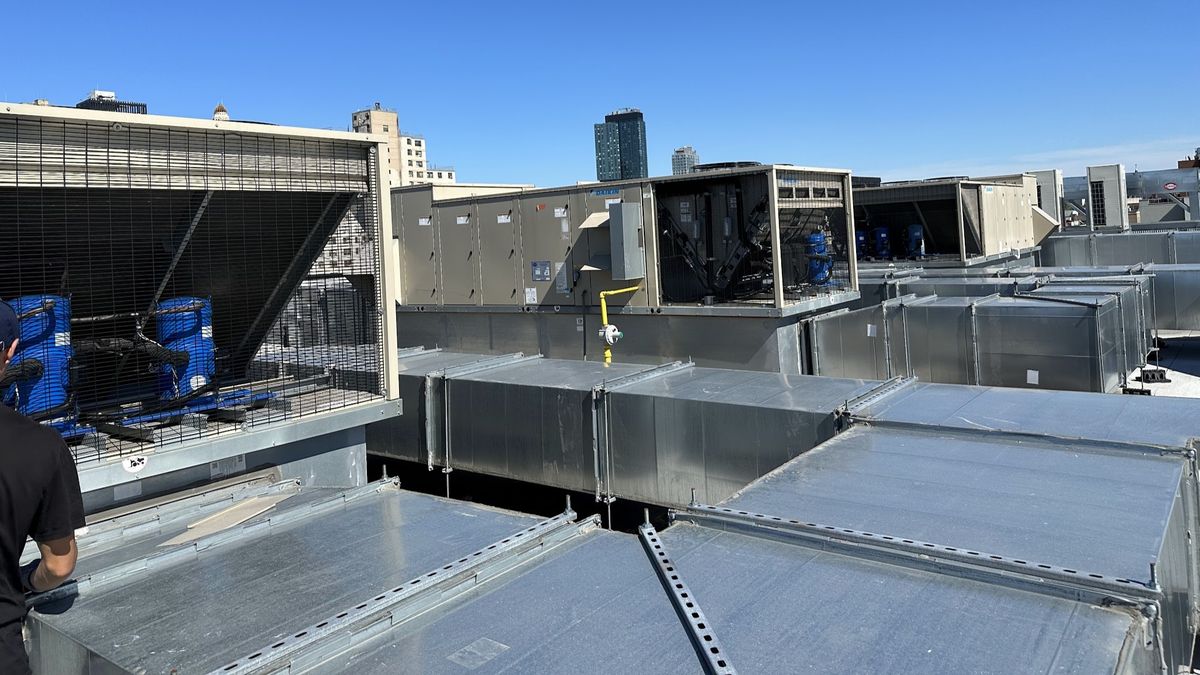 Art HVAC Technician Performing Scheduled Commercial HVAC Maintenance at a NYC Retail Storefront Rooftop Unit Visit