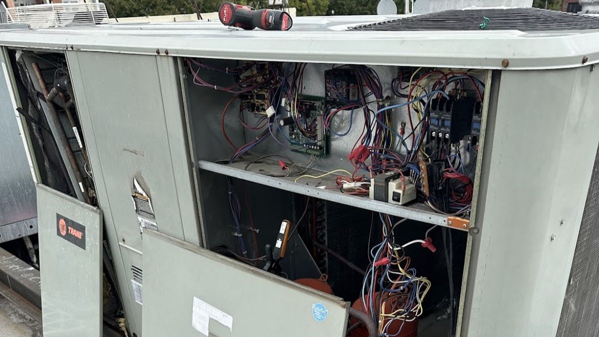 Art HVAC Technician Servicing a Trane Commercial Rooftop HVAC Unit on a NYC Office Building During Scheduled Tune Up
