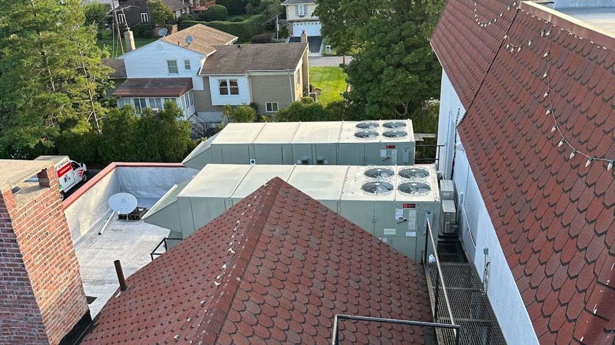 Art HVAC Field Technician on a Bronx NY Rooftop Performing Commercial HVAC Repair and Seasonal Maintenance Service