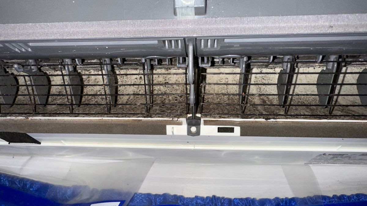 Art HVAC Technician Inspecting a Commercial AC Unit Showing Classic Signs of Refrigerant Leak at a NYC Office Building