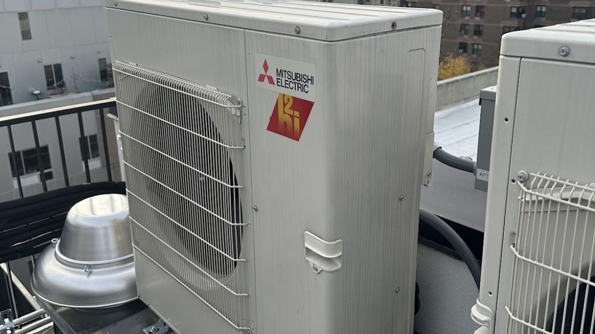 Art HVAC Installer Mounting a Mitsubishi Electric City Multi Outdoor Unit at a NYC Commercial Office Building Site