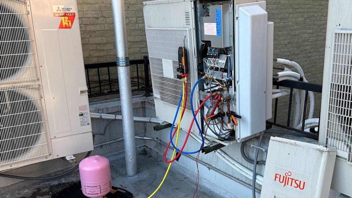 Art HVAC Installer Mounting a Fujitsu Ductless Mini Split Indoor Head at a New York City Brownstone Apartment Building