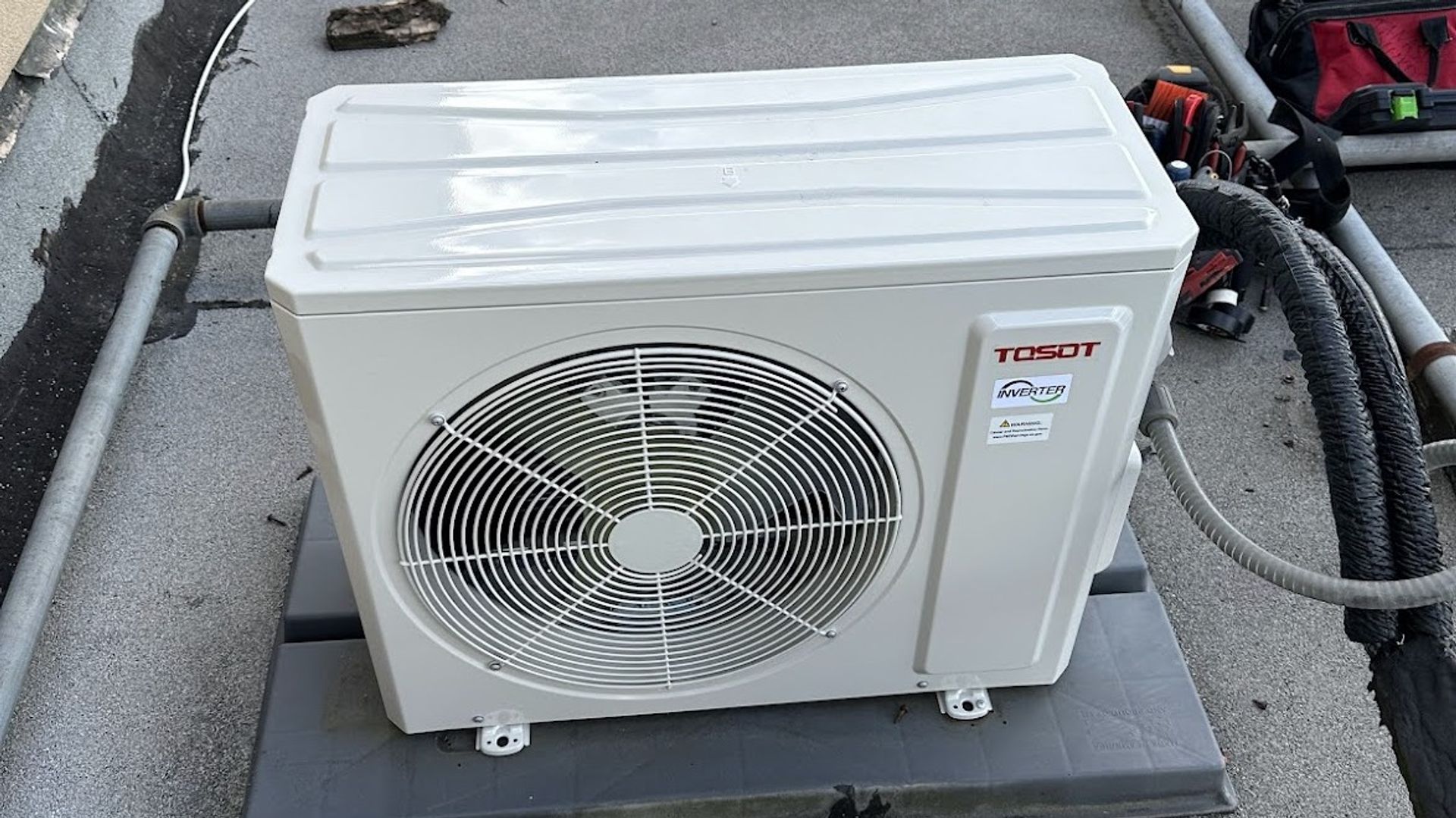 Art HVAC Installer Mounting a Ductless Mini Split Indoor Head on a Brick Wall at a NYC Commercial Office Property