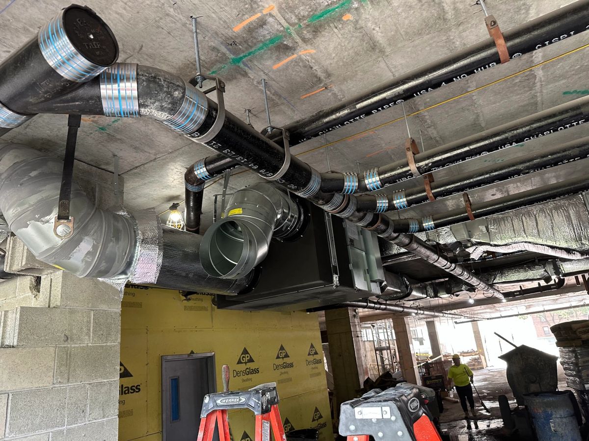 Art HVAC technician completing a central air conditioning installation at a NYC property
