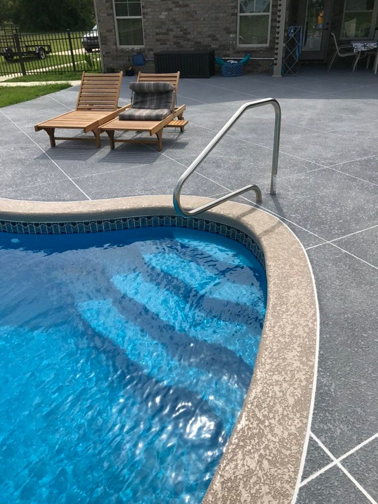 Beige and gray Kool Deck pool surface with decorative coping