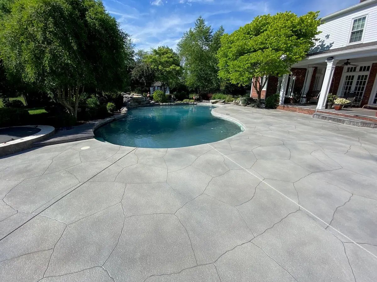 Light gray stone-etched pool deck surface