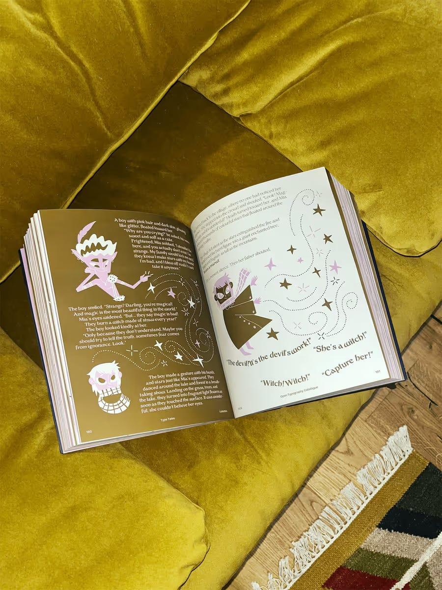 Open Type Tales book with fairy-tale illustrations on a yellow chair.