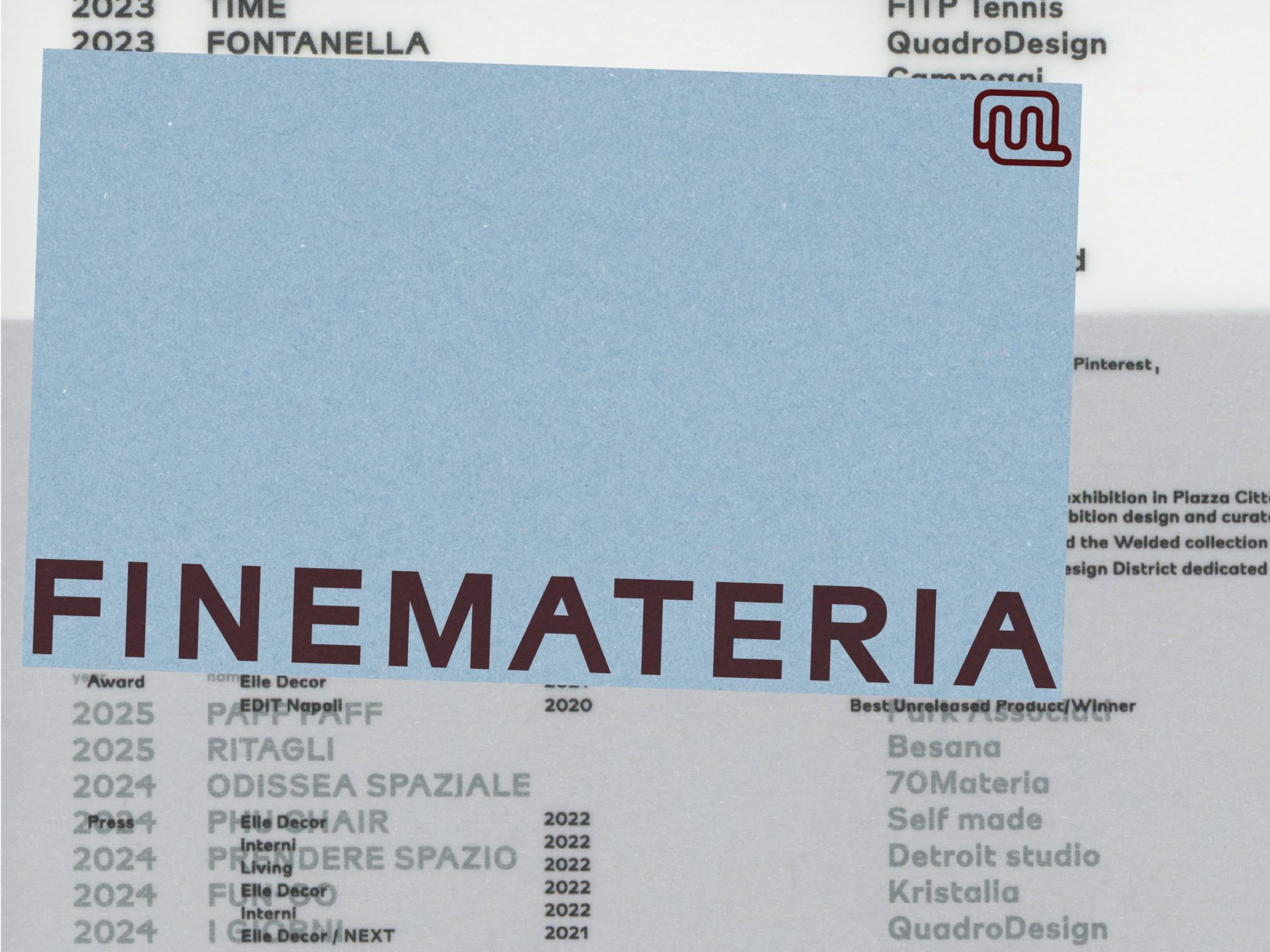 Cropped pale-blue poster with large dark-red “FINE MATERIA” lettering.