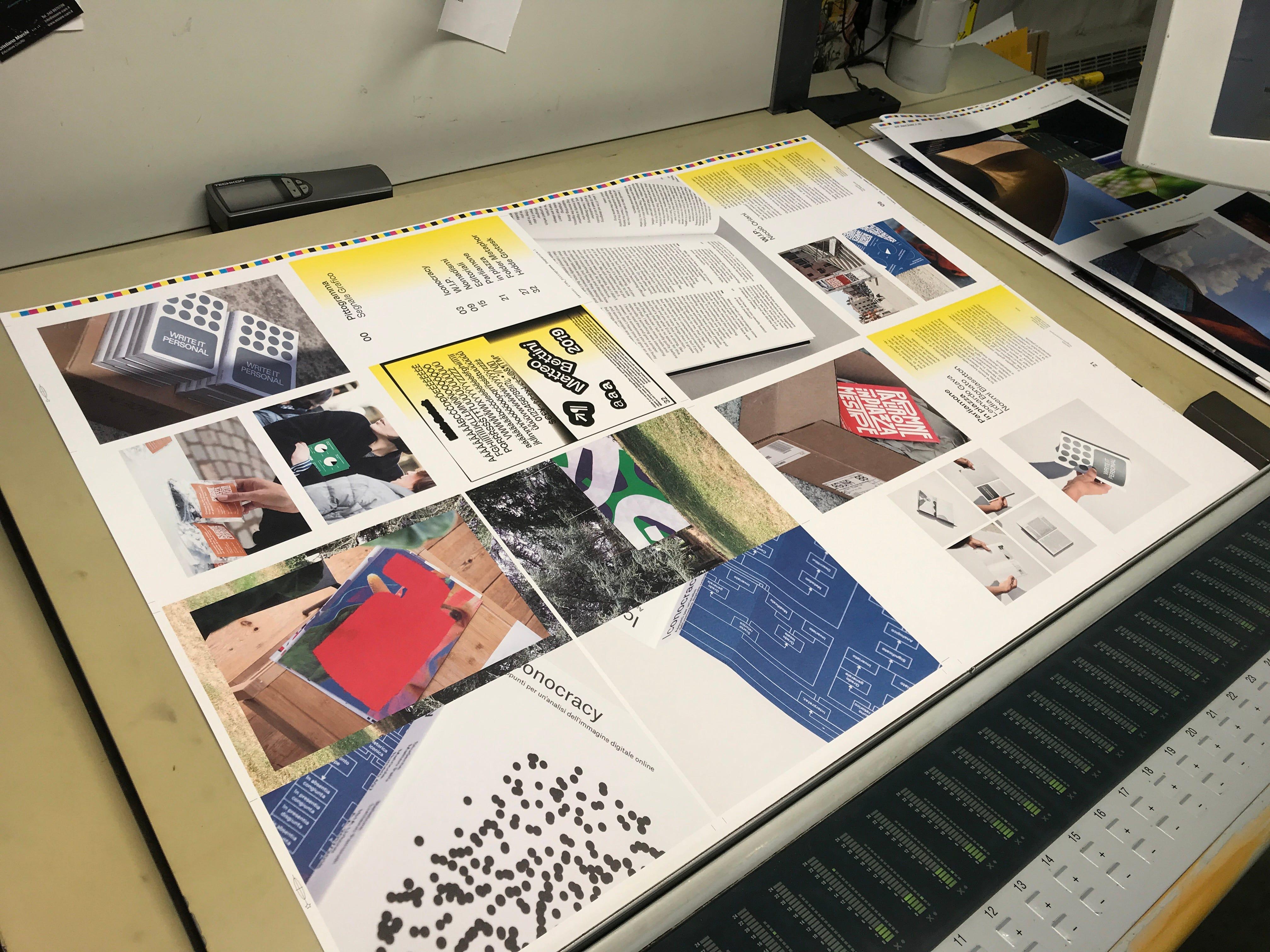 Printed P00 sheets on a press proofing table, with colour bars and image layouts.