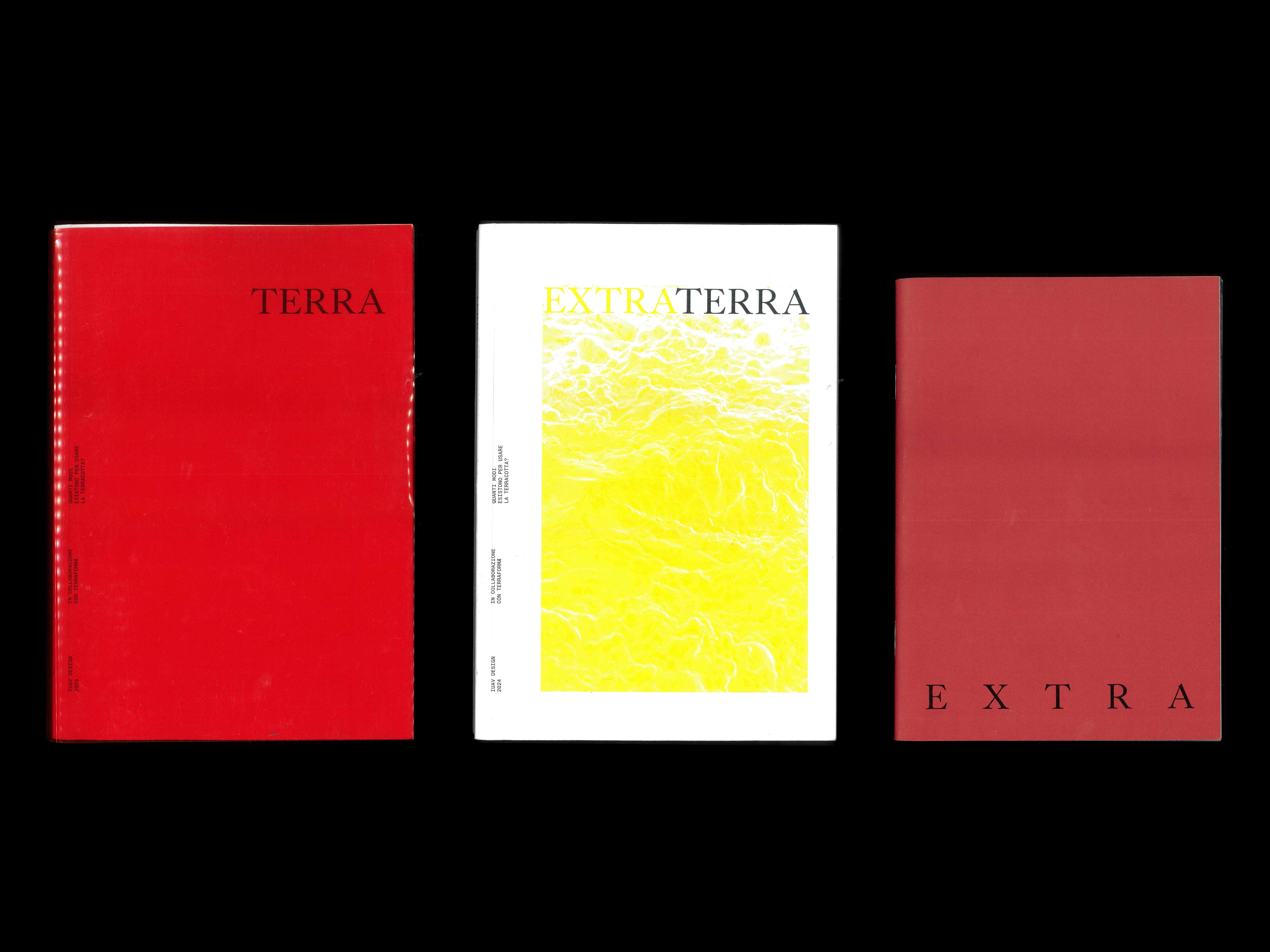 Red, yellow and white Extraterra books on a black background.