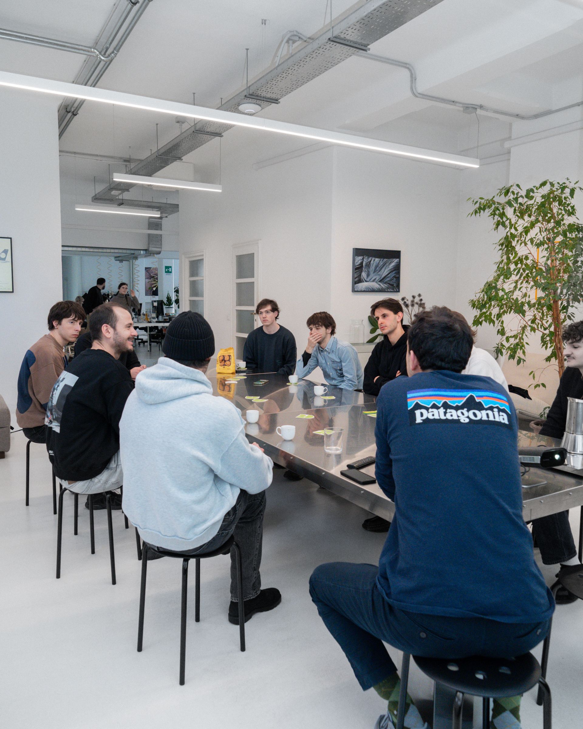 Attendees seated around a table during the Giga studio visit.