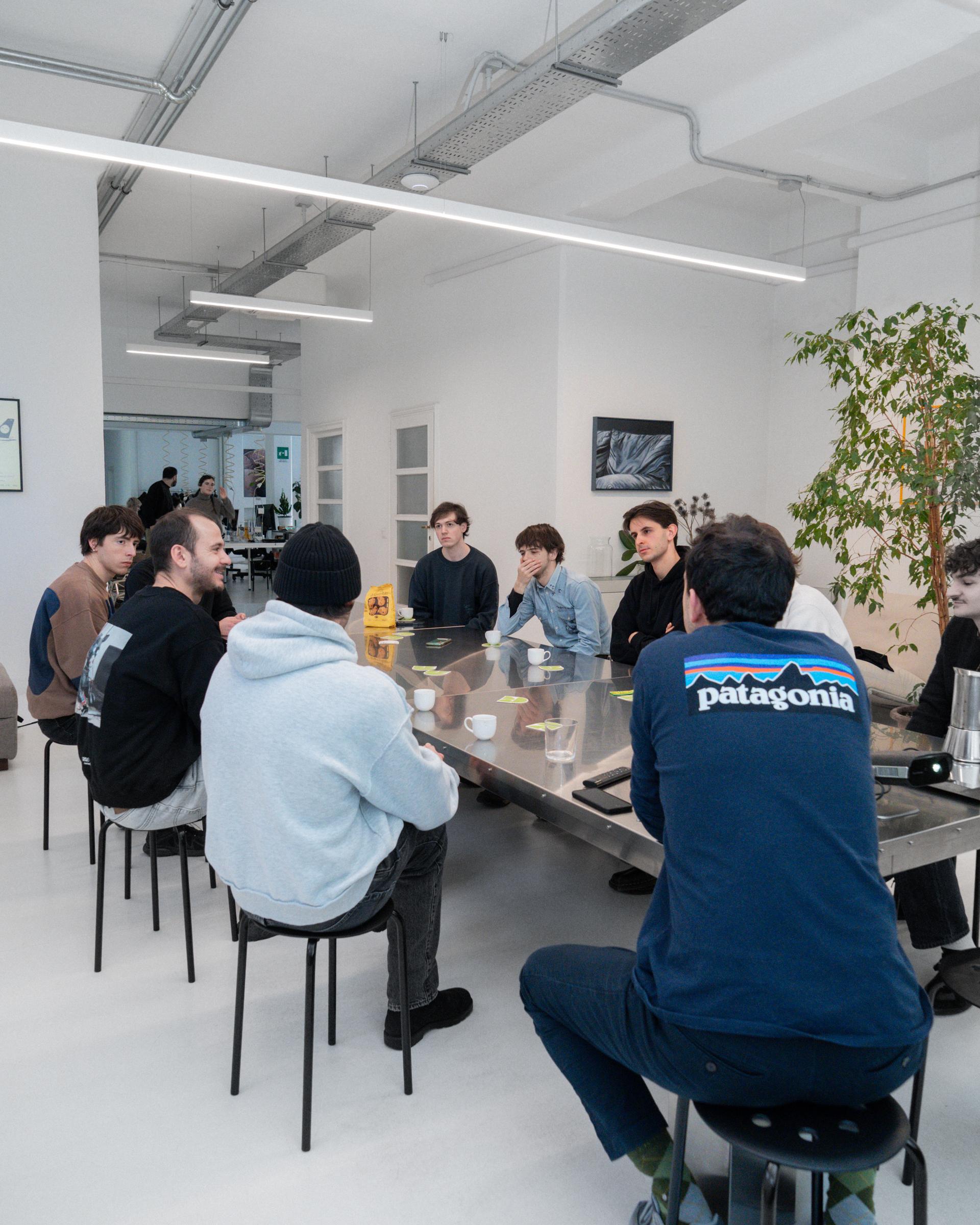Attendees seated around a table during the Giga studio visit.