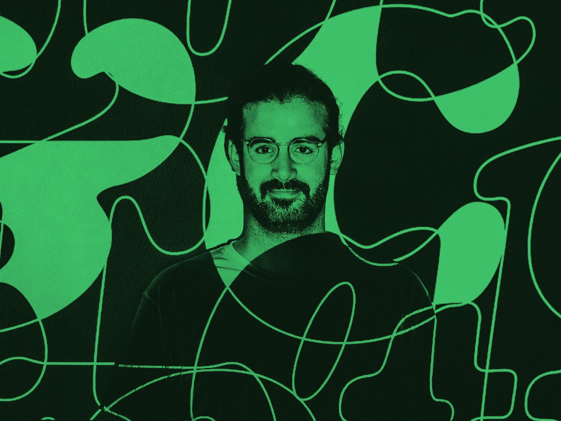 Green-tinted portrait of a person wearing glasses against an abstract black-and-green graphic background.