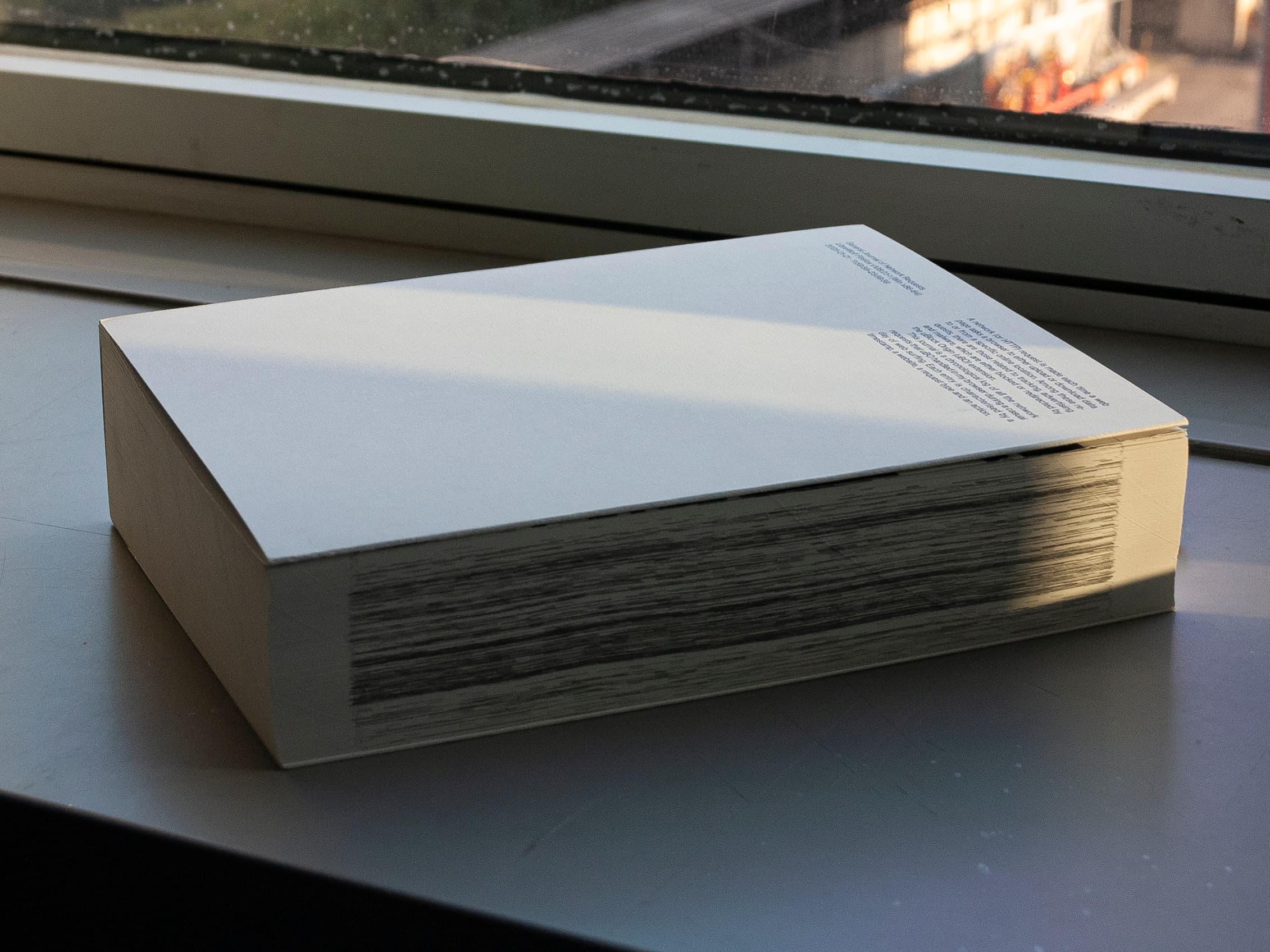 White General Journal of Network Requests publication resting on a windowsill.