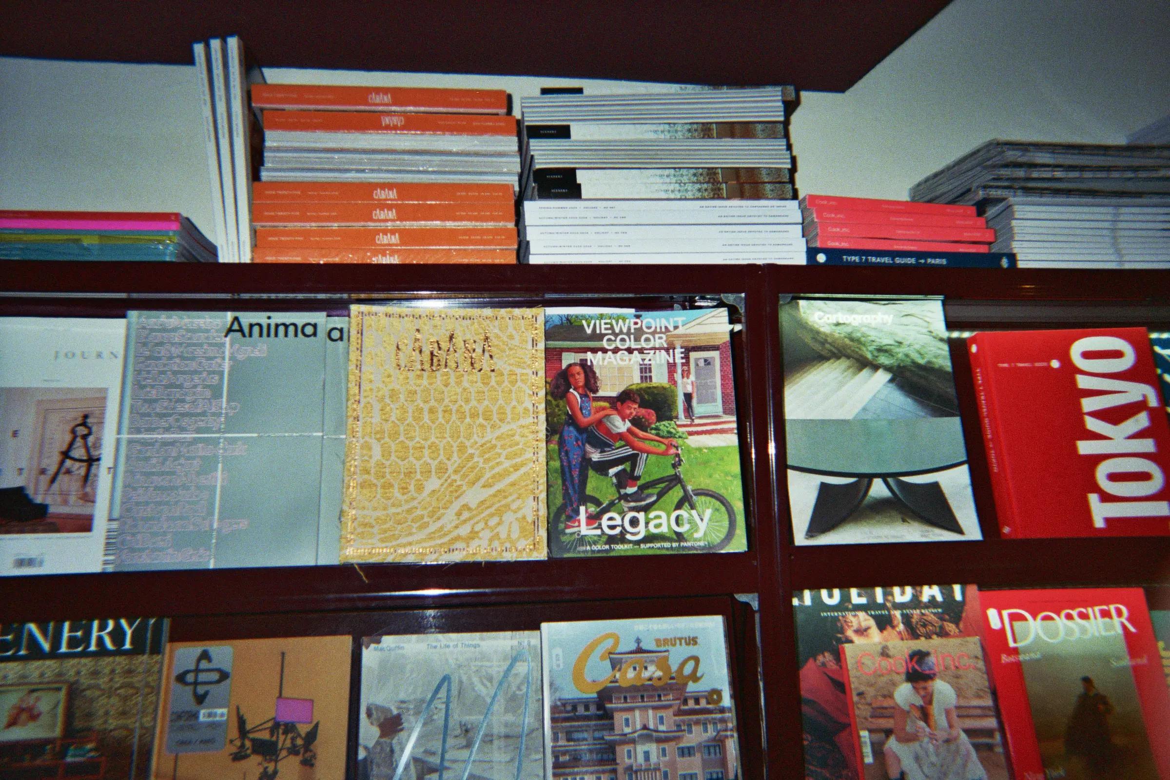 Stacks and rows of magazines on red shelves at Frab's Magazines & More.