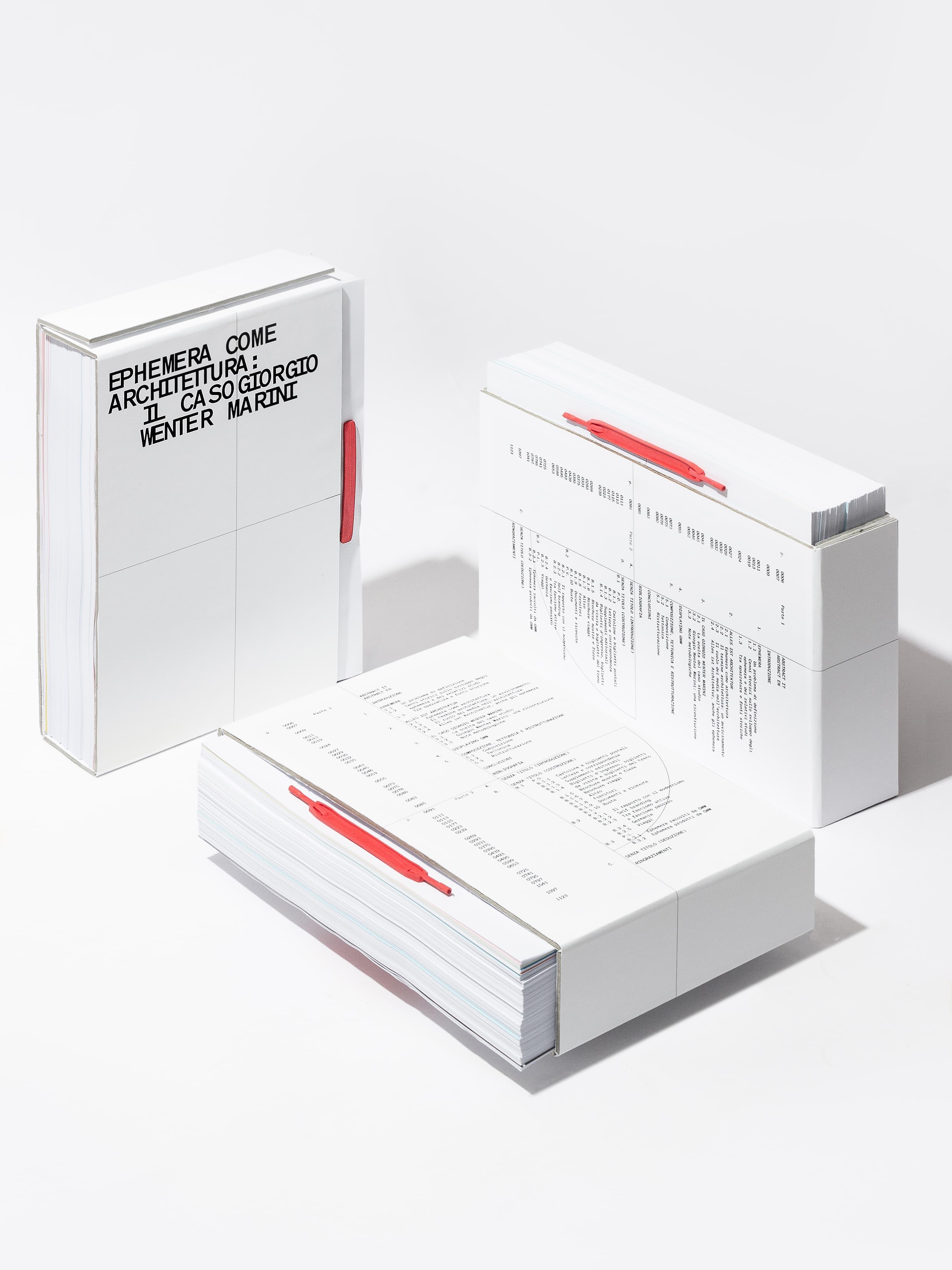White Ephemera publication and boxed volumes with red plastic binding elements.