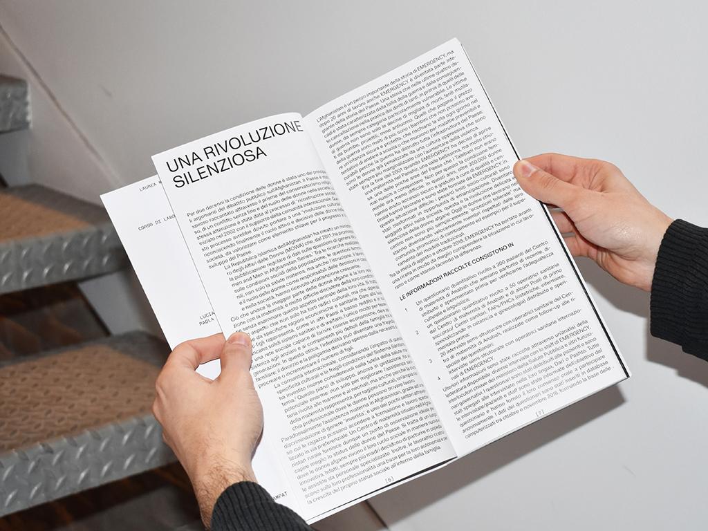 Hands holding open the Brick by Brick publication to a spread titled “Una rivoluzione silenziosa.”