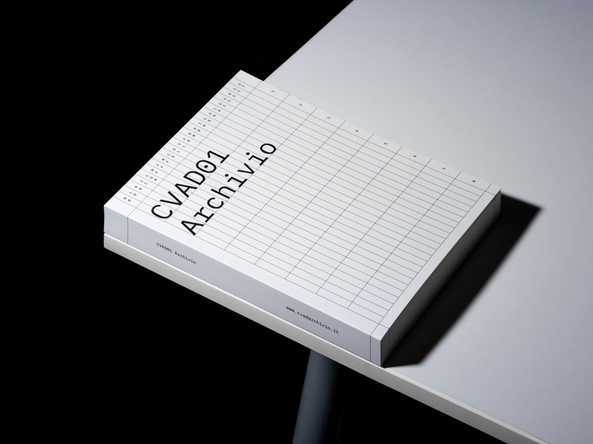 White CVADO1 Archivio book on a black stool.