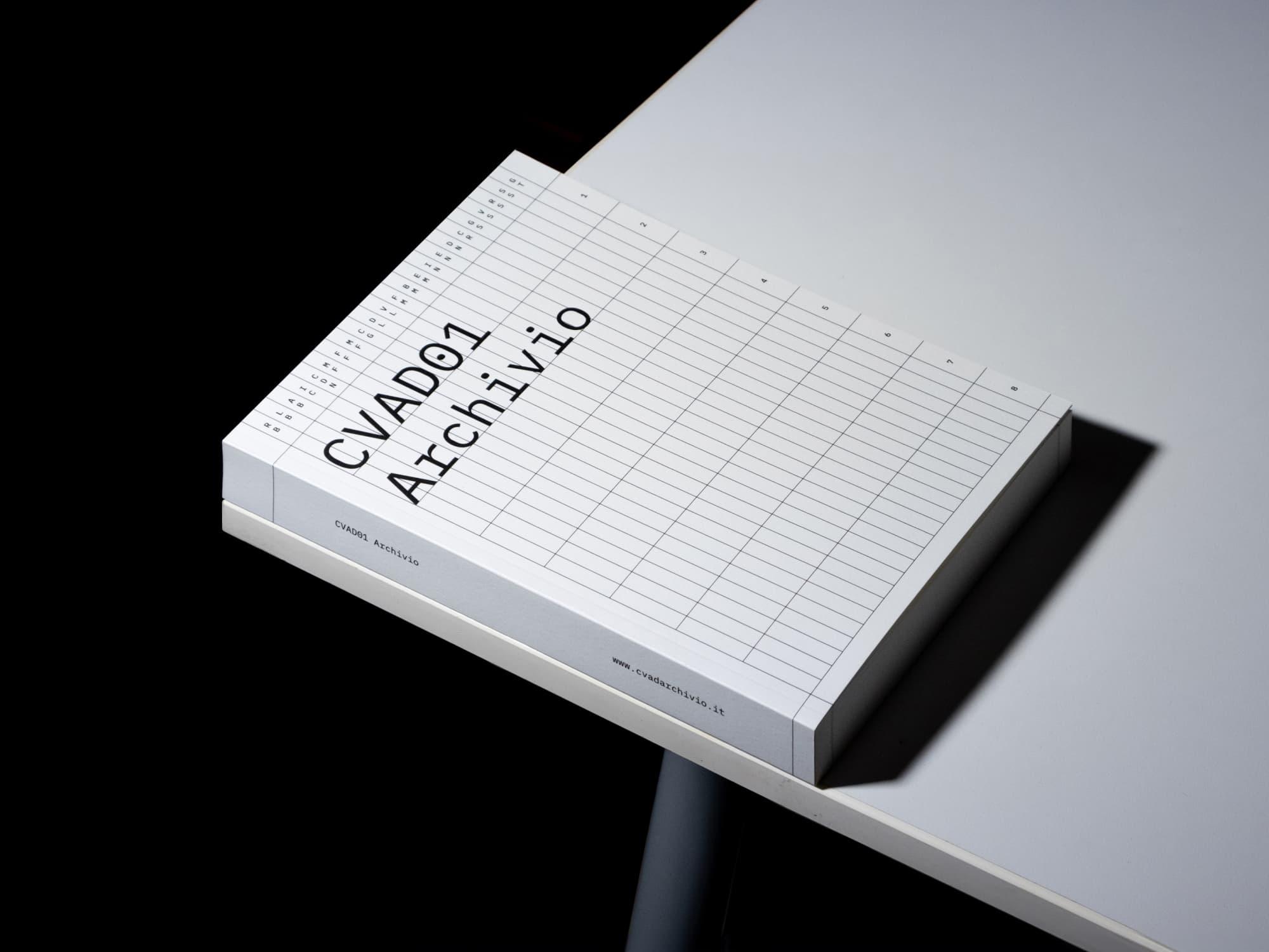 White CVADO1 Archivio book on a black stool.
