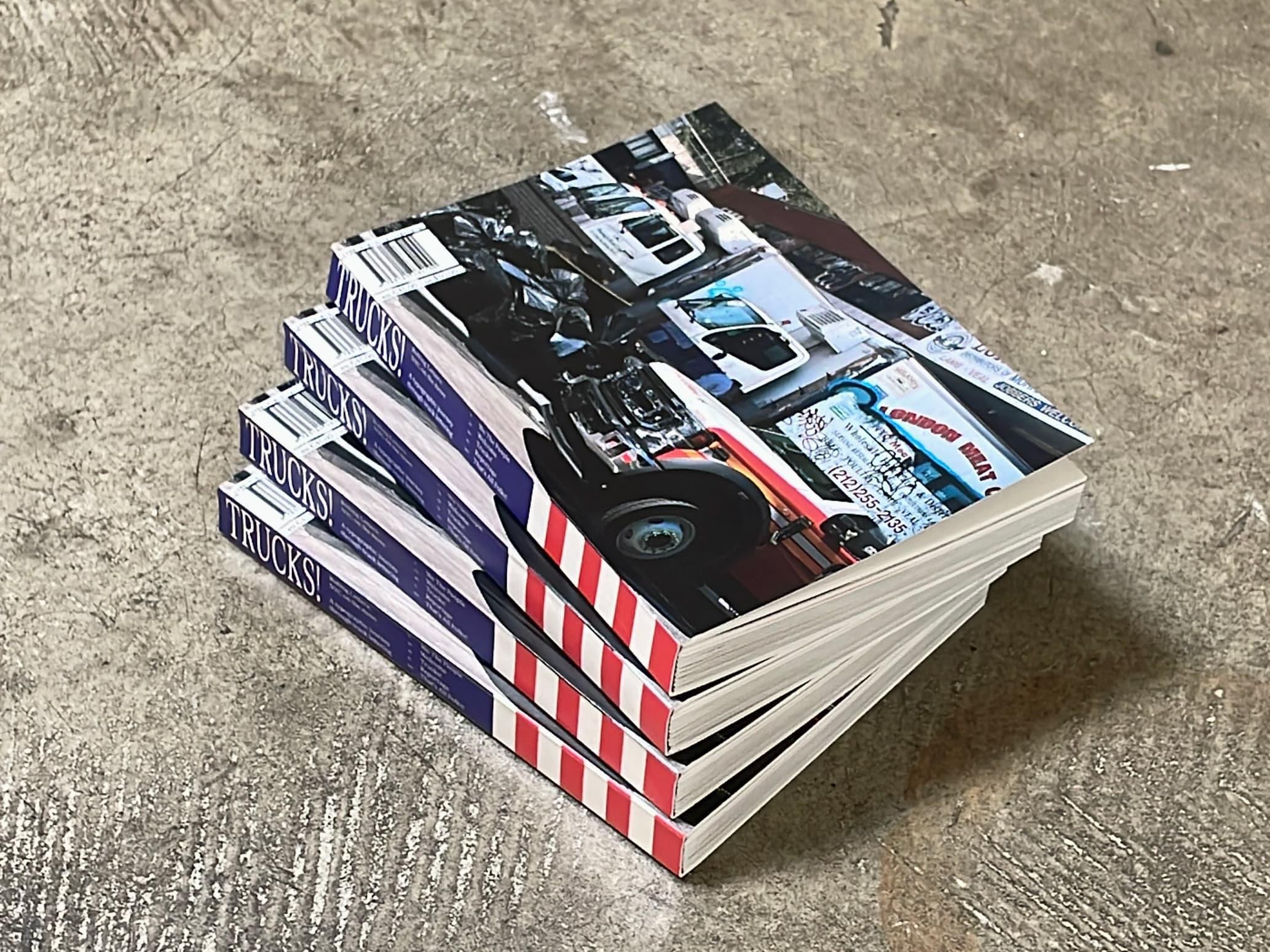 Stack of TRUCKS! books with a vehicle photograph and red striped spines.