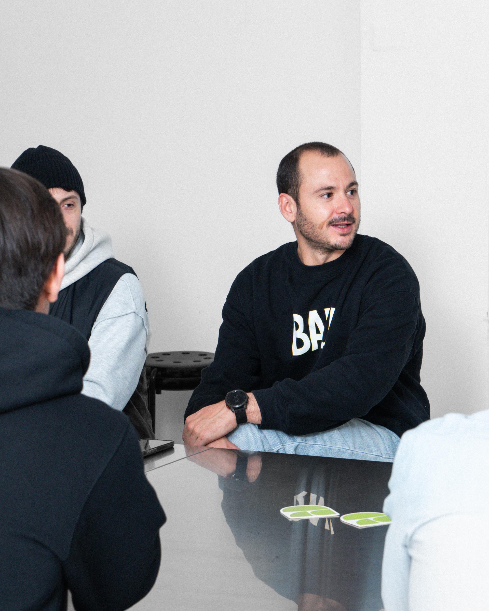 Attendees seated around a table during the 5+1 visit at Giga.