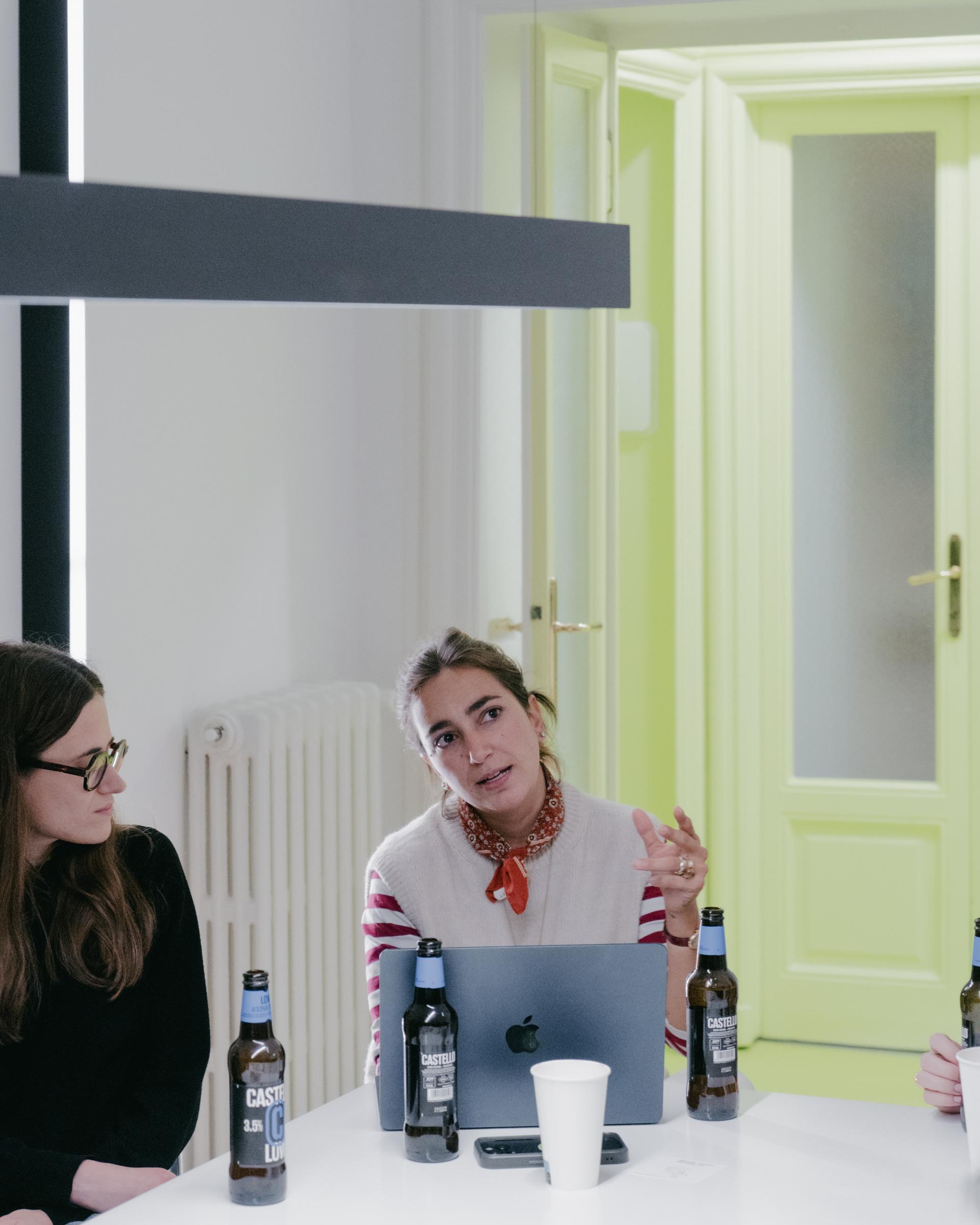 Participant presenting at a table with a laptop and Castello bottles.