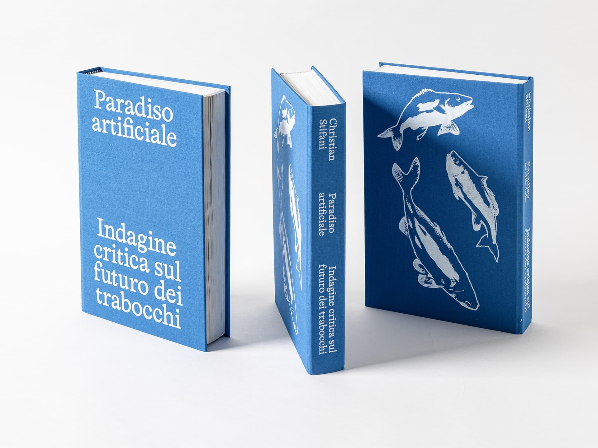 Three blue Paradiso artificiale books with white whale illustrations.
