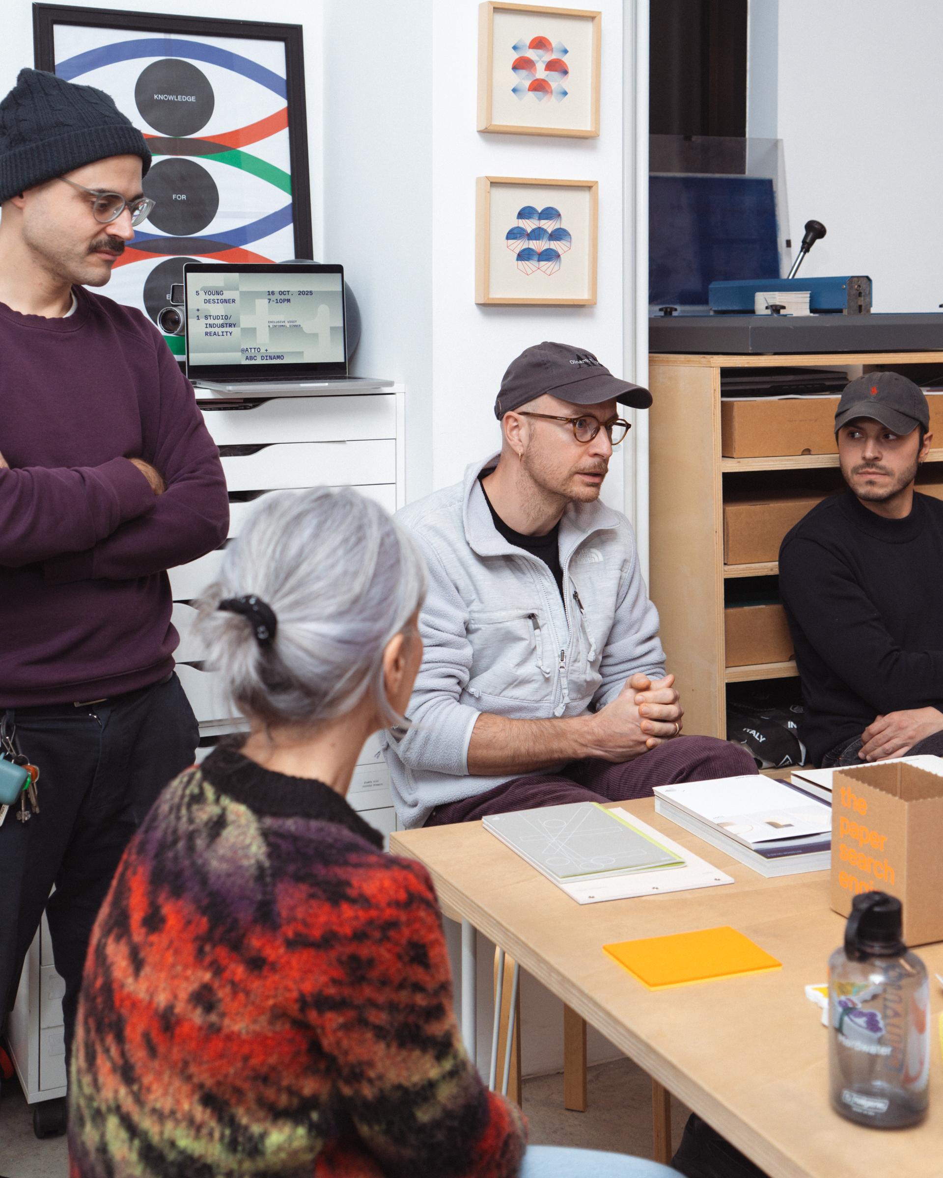 Participants in discussion around a table in the Atto studio.