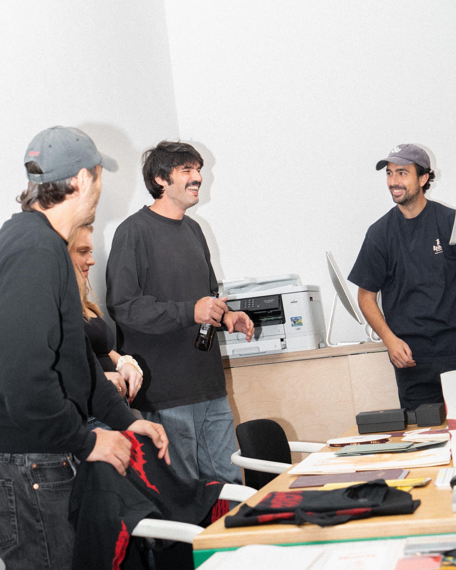 Attendees gathered around a worktable in the Ascionemagro studio.