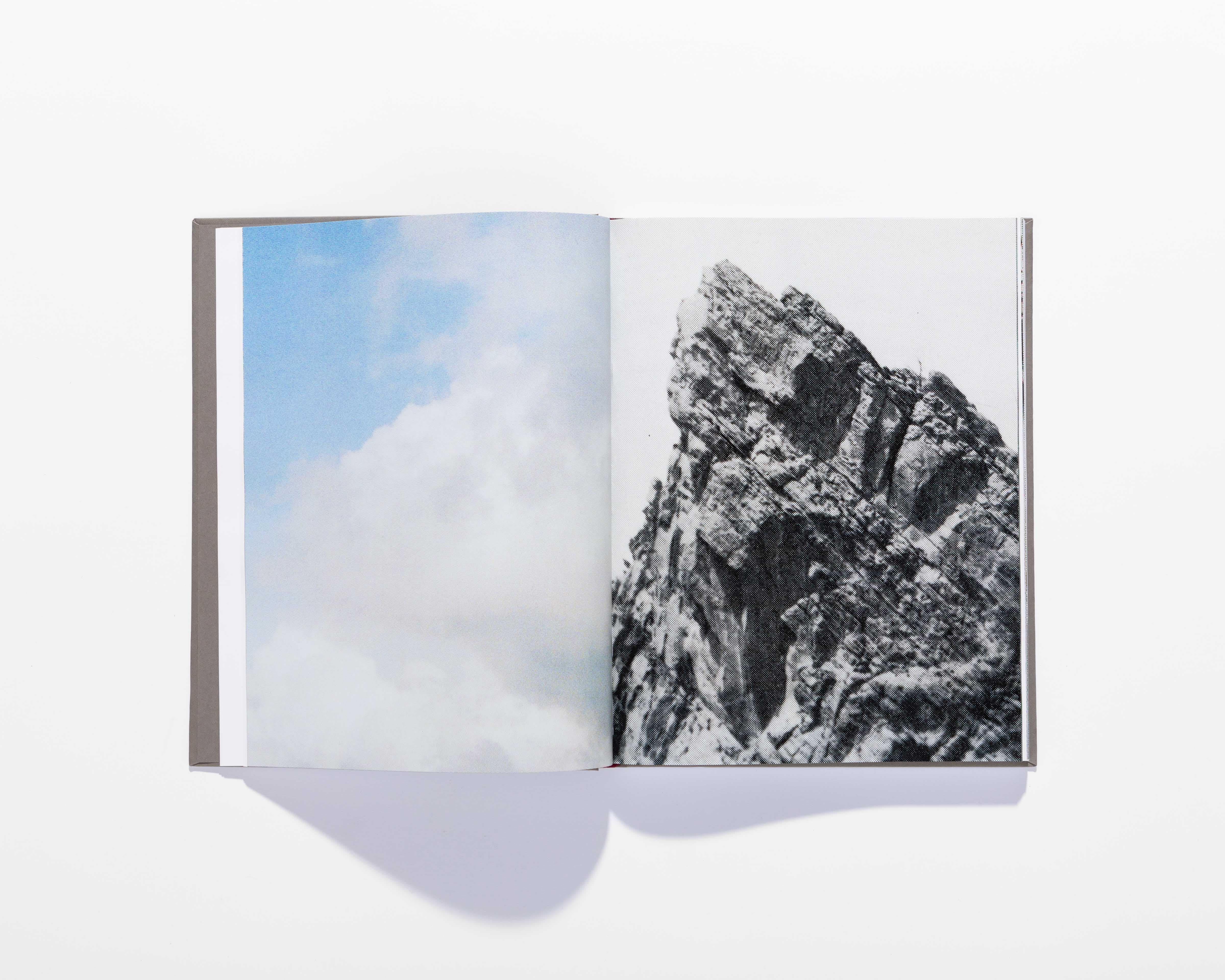 Open Il Crampo di Gesso book with a blue-sky photograph beside a black-and-white rock image.