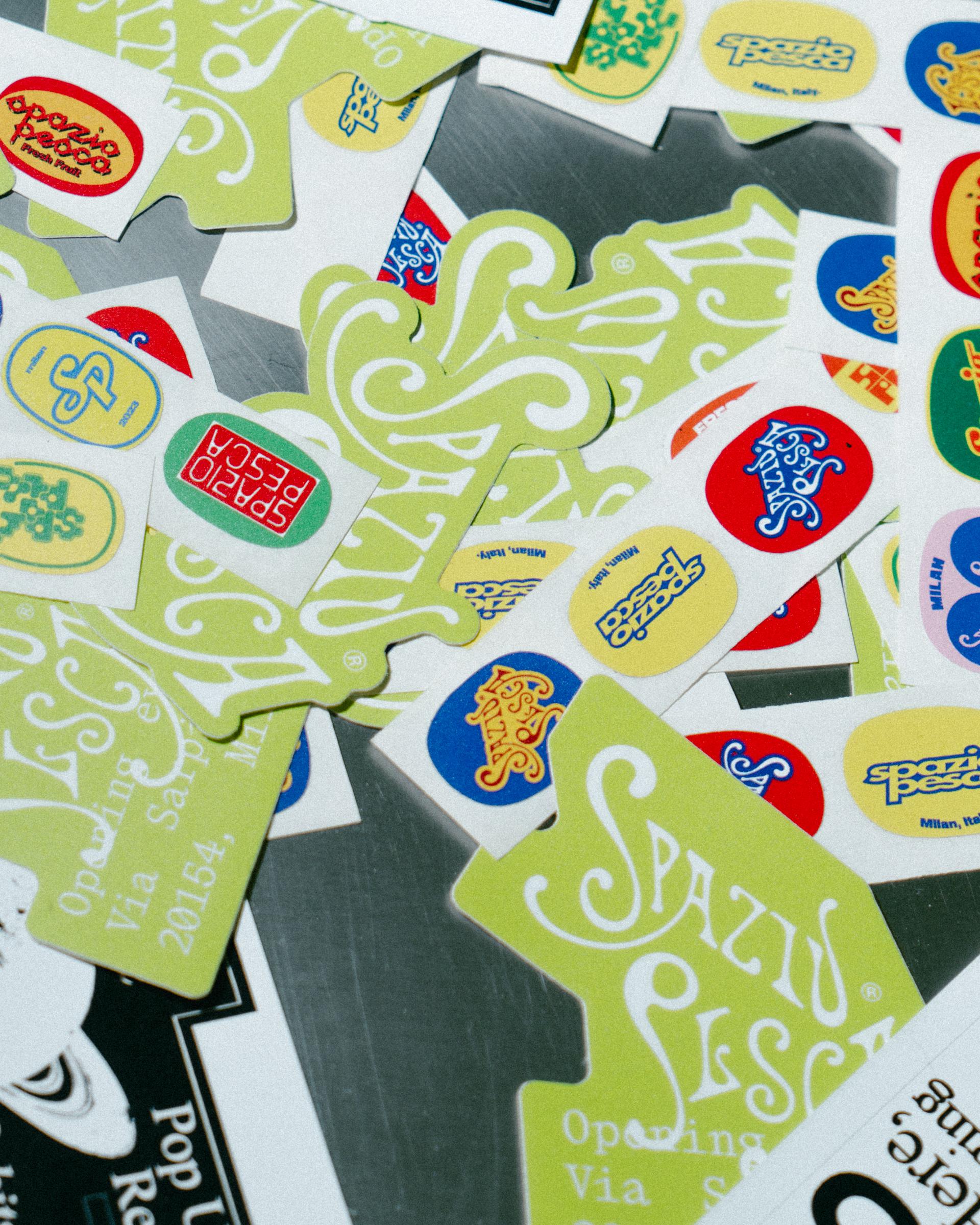 Studio Pesca and 5+1 stickers scattered across printed material.